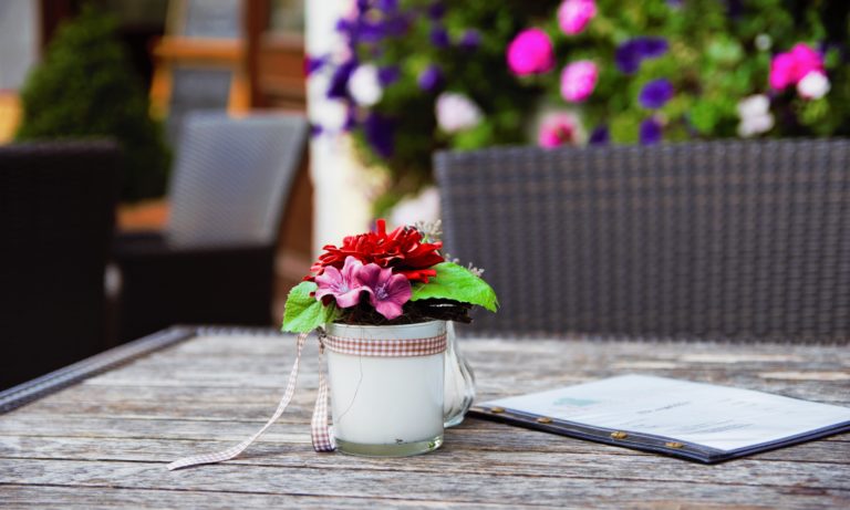 colourful-flowers-sitting-on-a-wood-table-on-a-custome-edmonton-deck