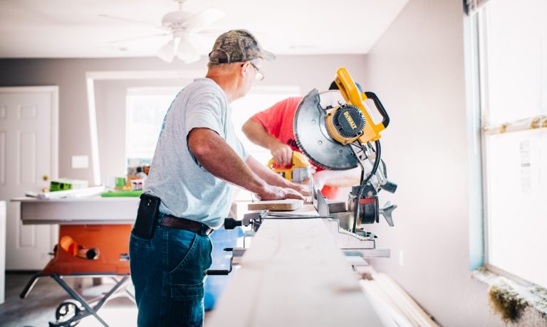 two-men-using-a-saw -to-renovate-their-edmonton-home-in-the-winter