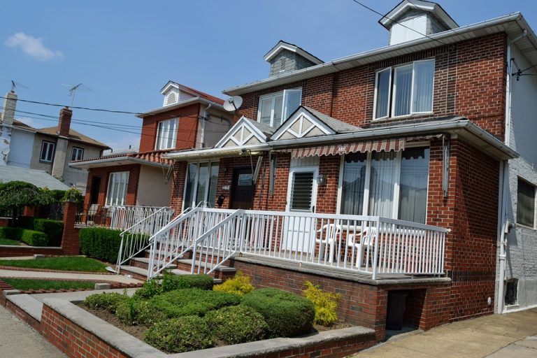 a-brick-house-in-edmonton-with-a-white-rail