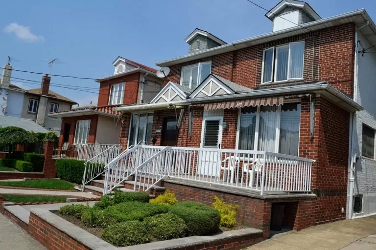 a-brick-house-in-edmonton-with-a-white-rail