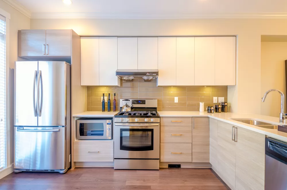 Modern, bright, clean, kitchen interior with stainless steel appliances in a luxury house