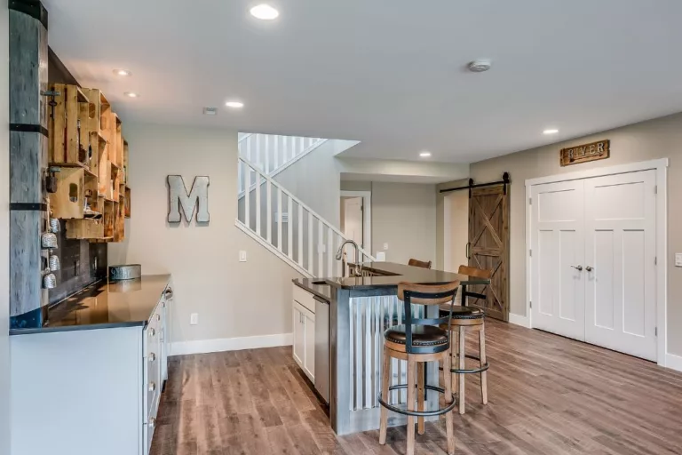 beautiful finished basement with wood floors and mini bar