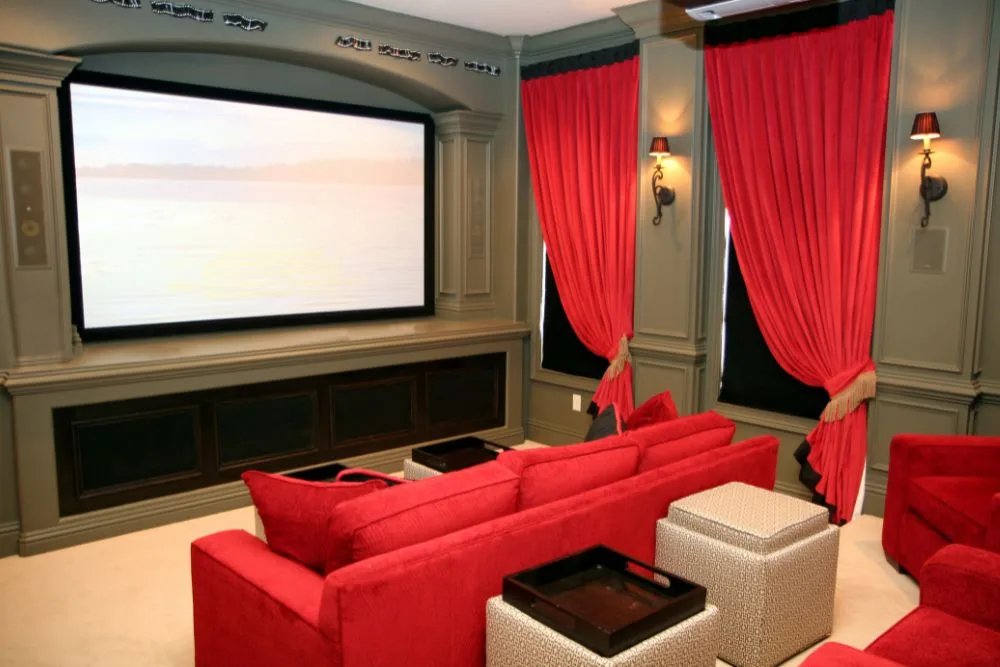 home theater with red sofas and curtains